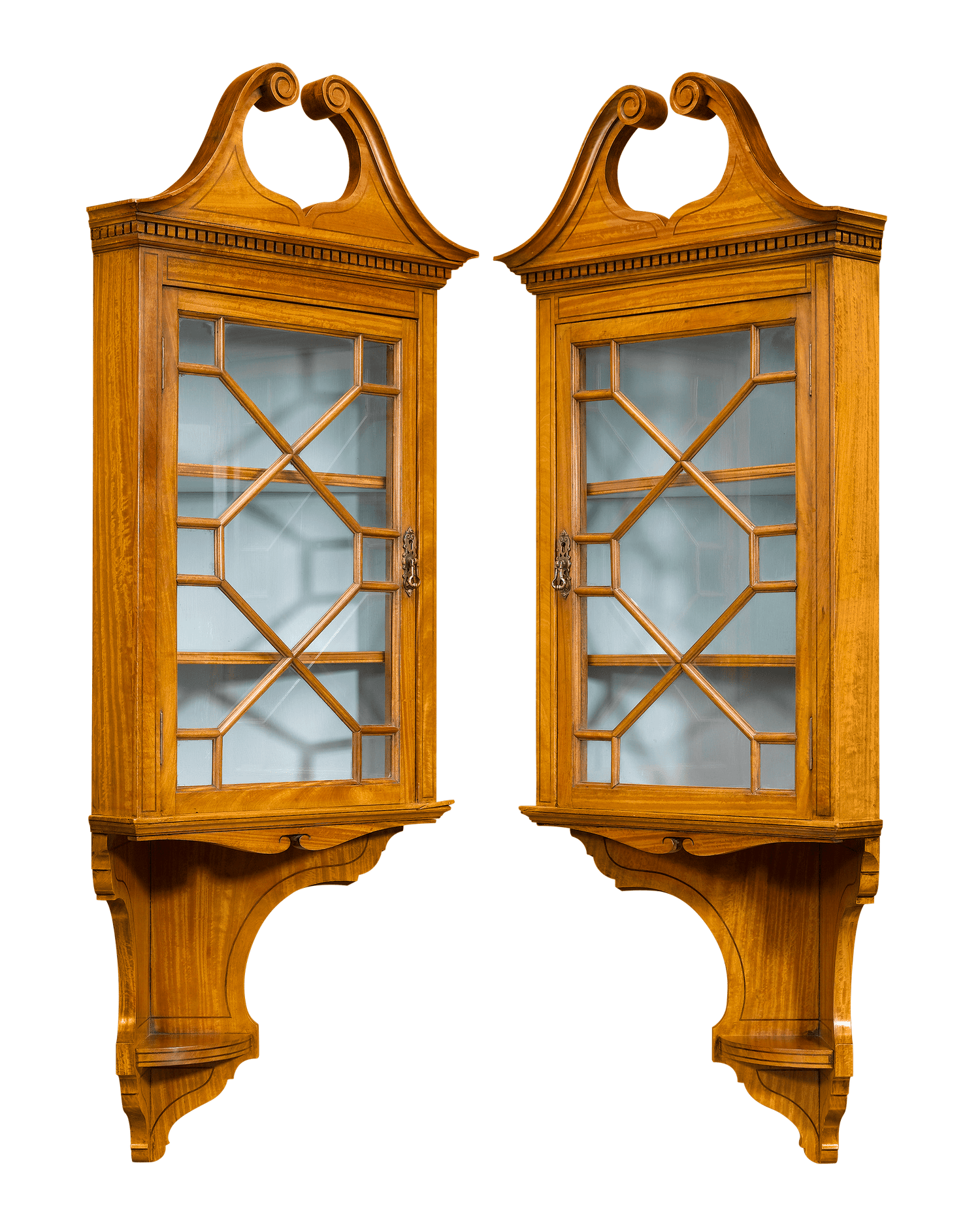 A beautiful pair of satinwood corner curio cabinets crafted in the Chippendale manner