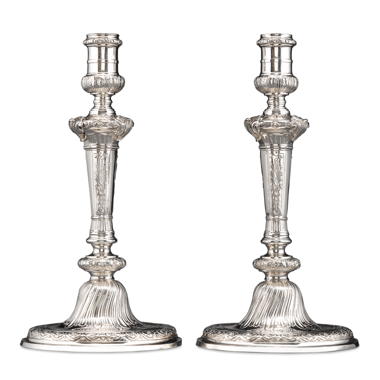 Stunning Rococo design distinguishes this pair of Georgian candlesticks