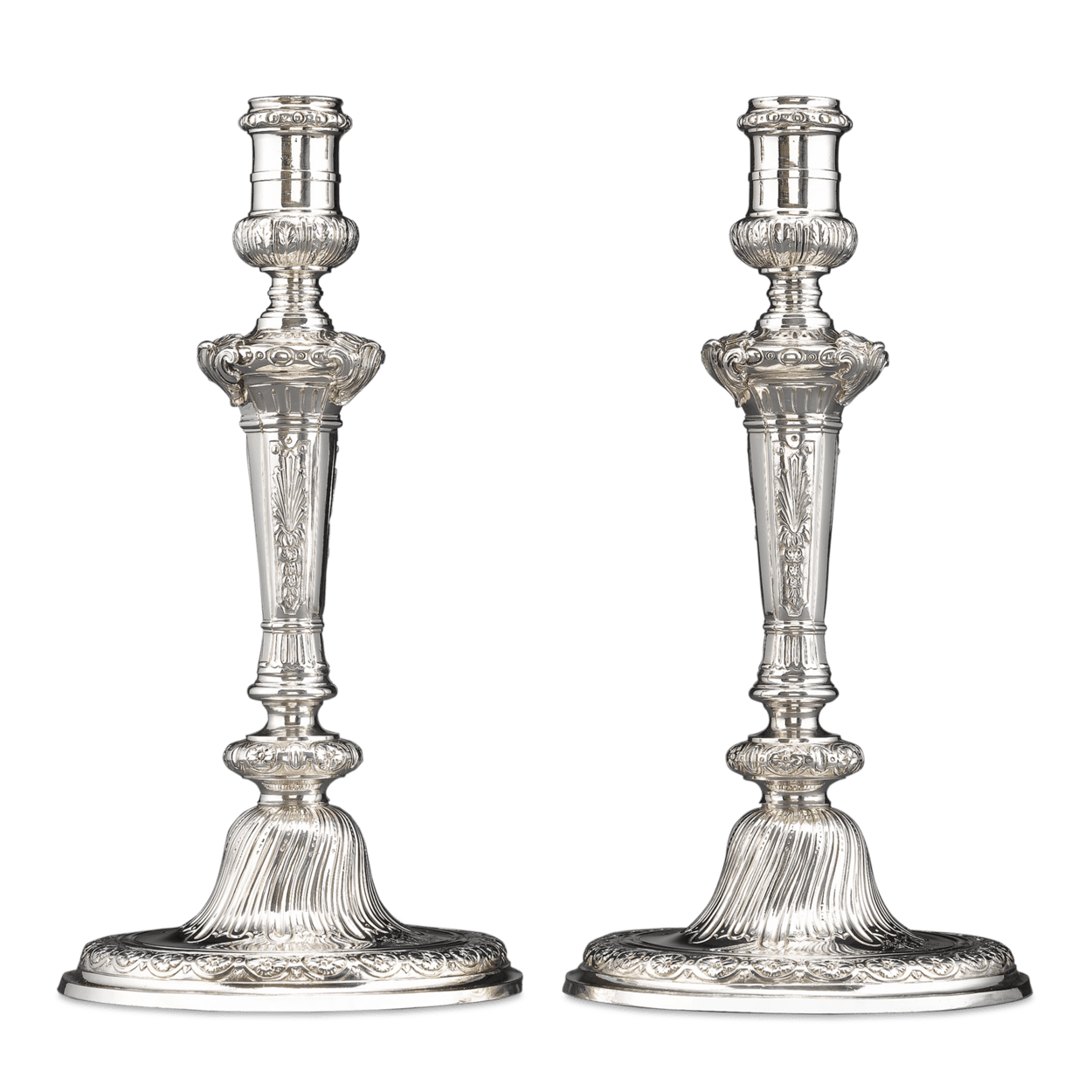 Stunning Rococo design distinguishes this pair of Georgian candlesticks