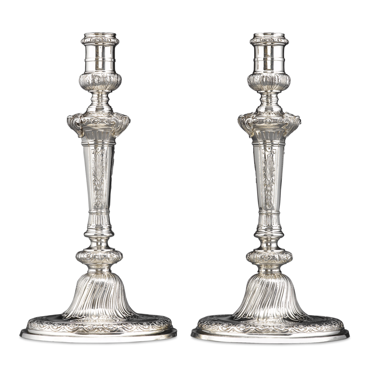 Stunning Rococo design distinguishes this pair of Georgian candlesticks