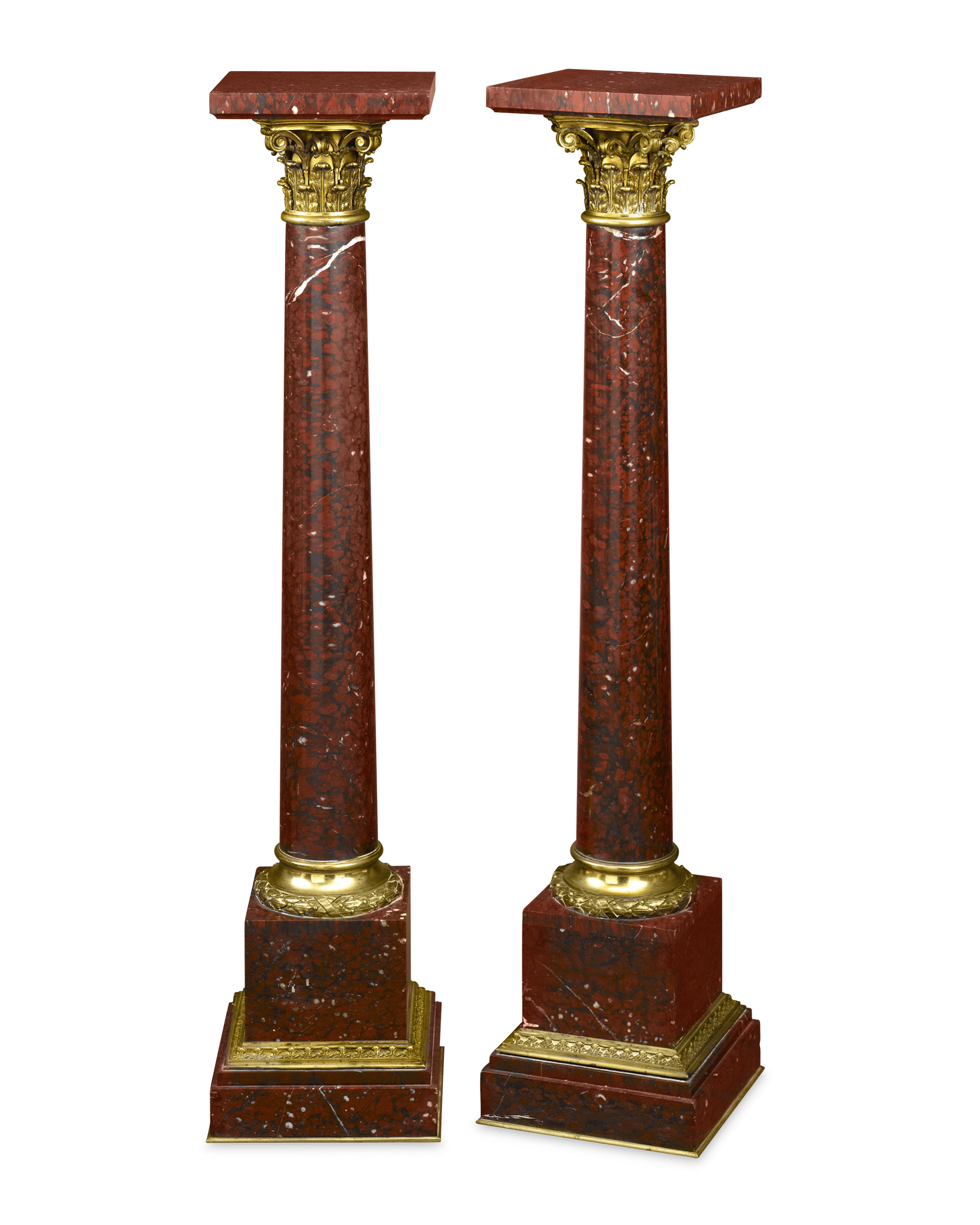 Crafted of rouge griotte marble, these pedestals take the form of Corinthian columns
