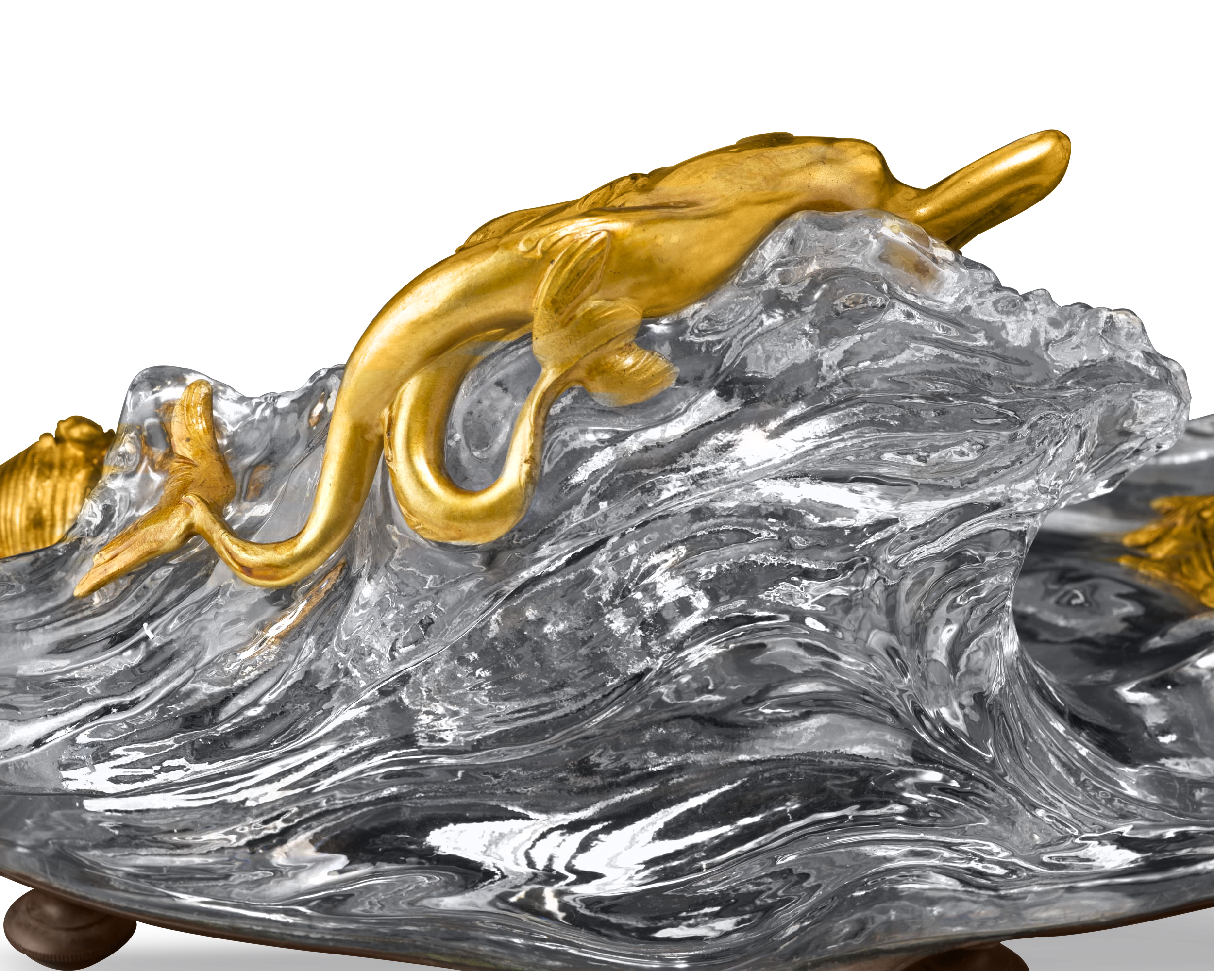 A seductive doré bronze mermaid reclines atop the crystal wave