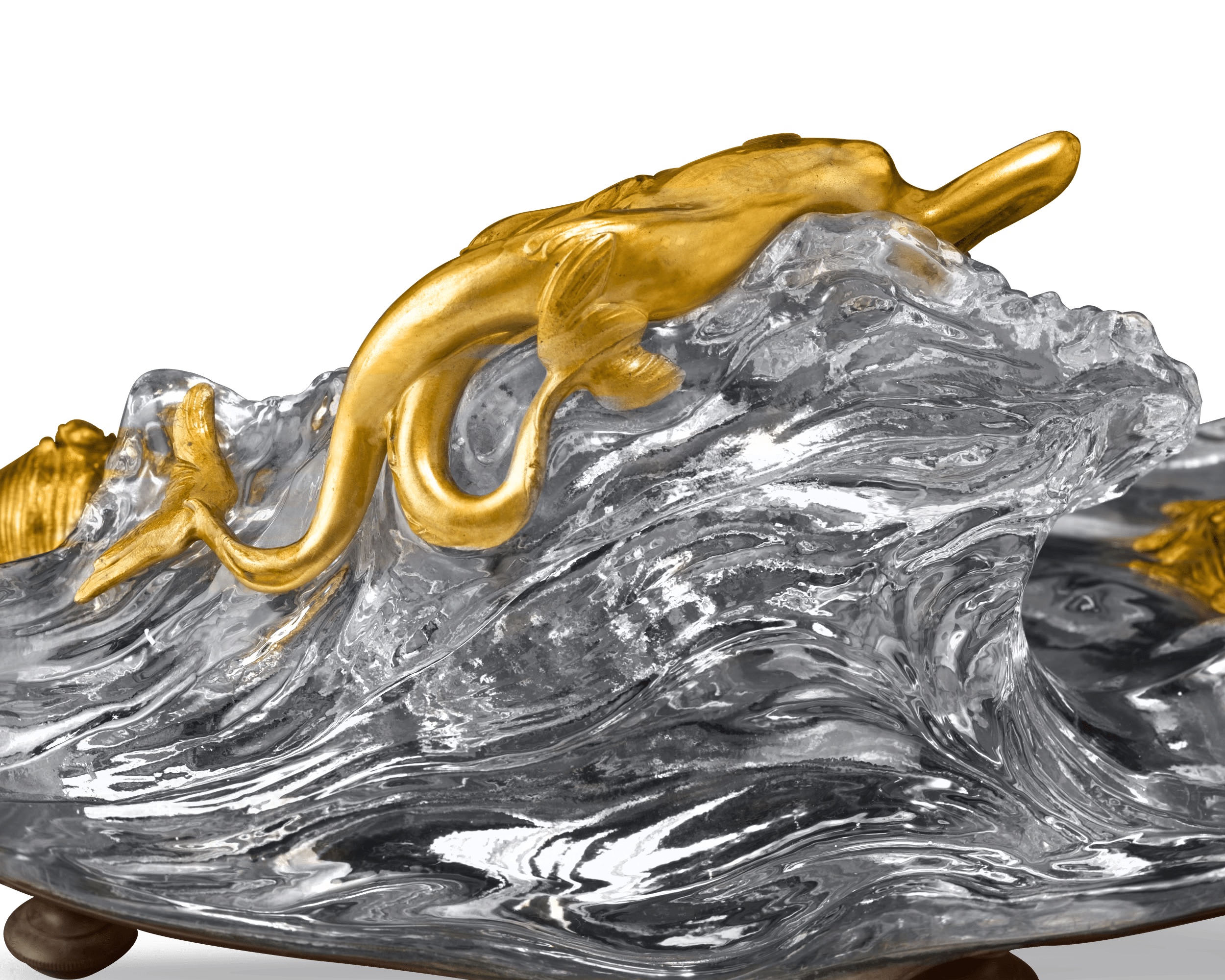A seductive doré bronze mermaid reclines atop the crystal wave