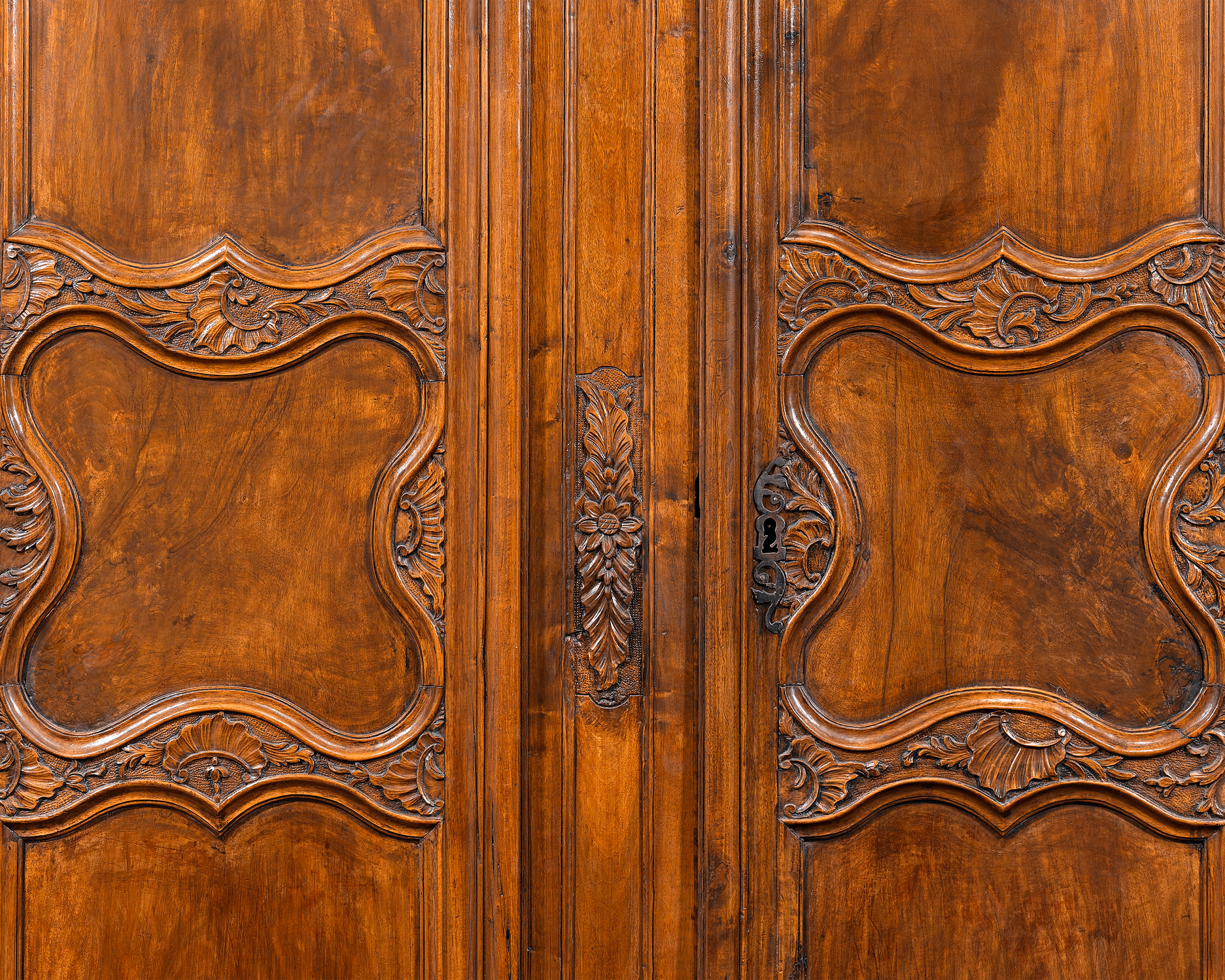 Elegant rocaille carvings distinguish this armoire