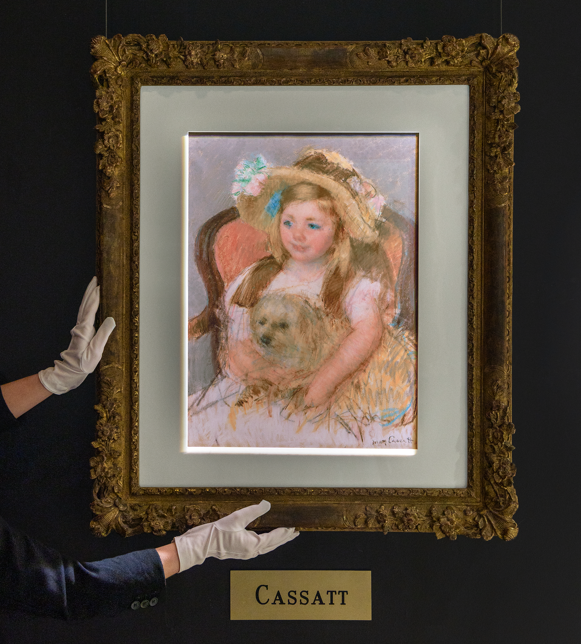 Smiling Sara in a Big Hat Holding Her Dog by Mary Cassatt